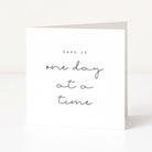 Motivational card with 'Take it one day at a time' text on a white background