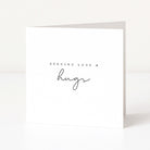 Greeting card with 'Sending Love & Hugs' text on a white background