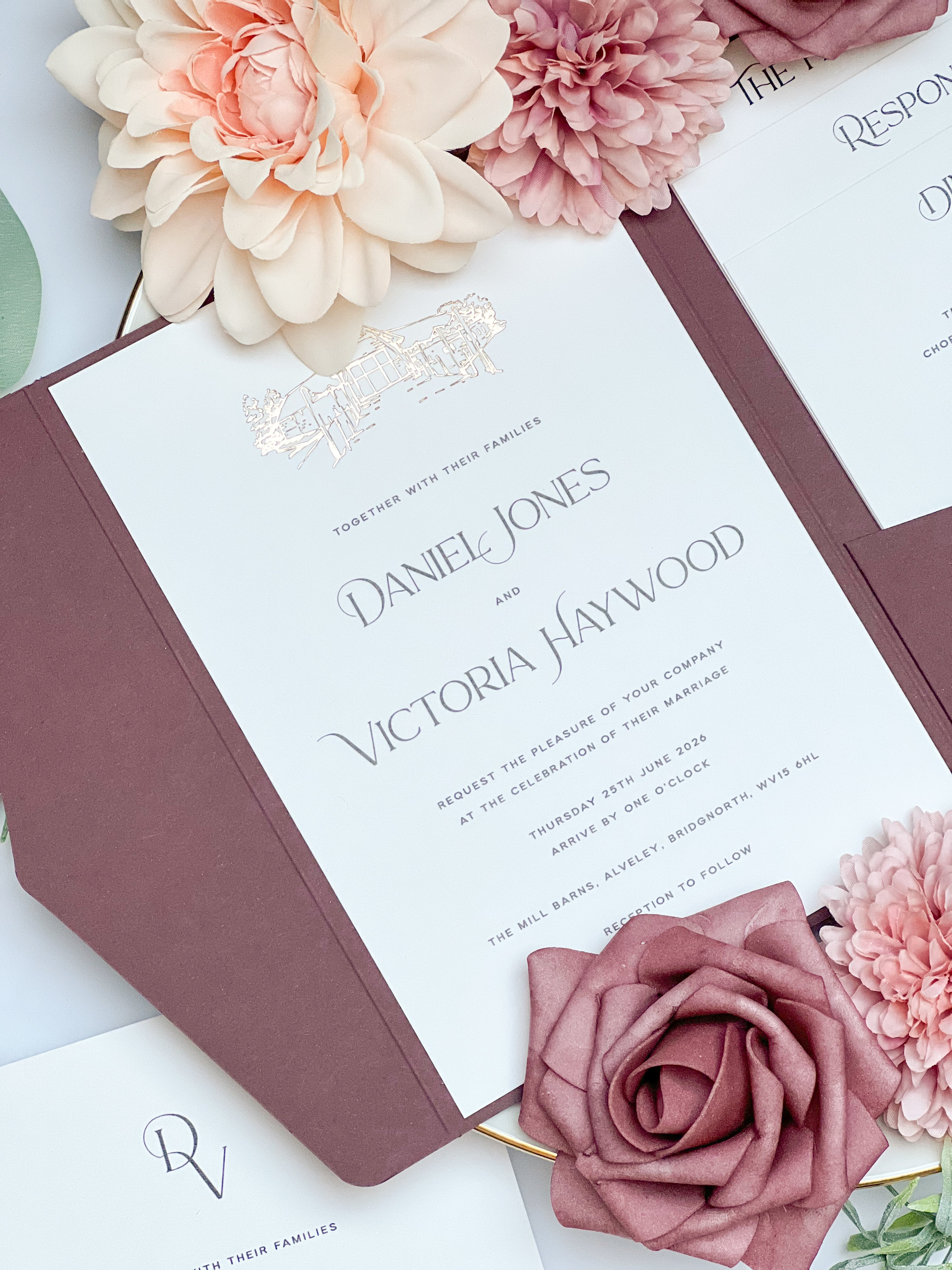 Wedding invitation card with floral decorations on a white background