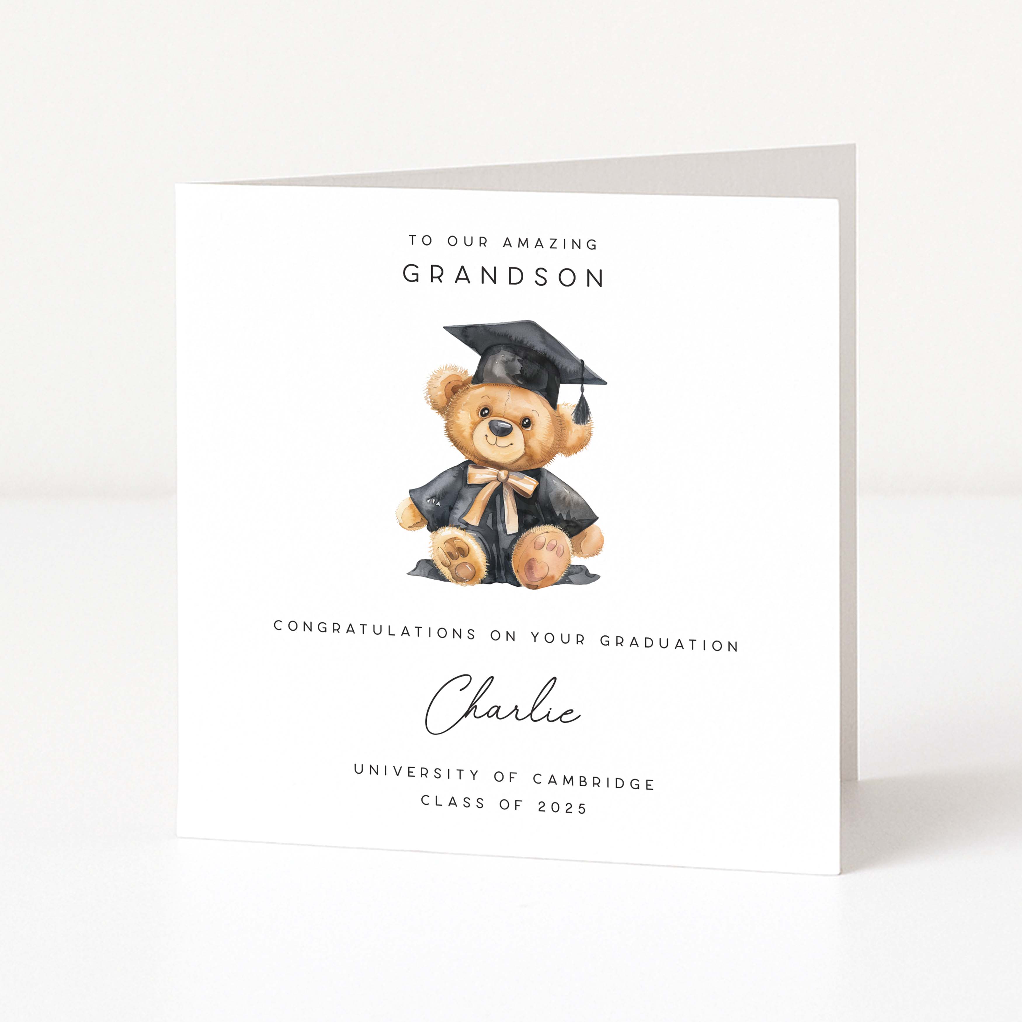 Graduation-themed card with a teddy bear in a cap and gown on a white background