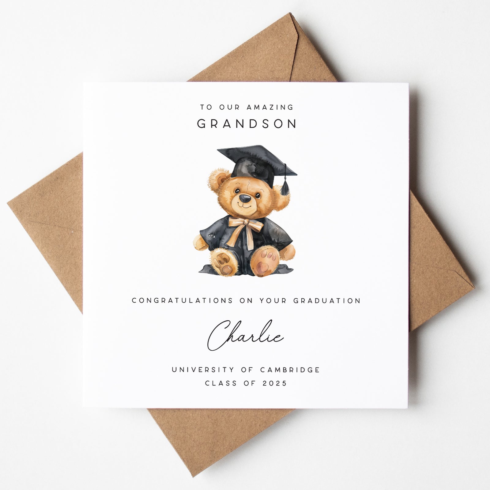 Graduation card with a teddy bear wearing a cap and gown, addressed to an amazing grandson, on a white background.