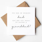 Greeting card with text 'You are an amazing dad but are you ready to become a granddad?' on a white background with brown envelope.