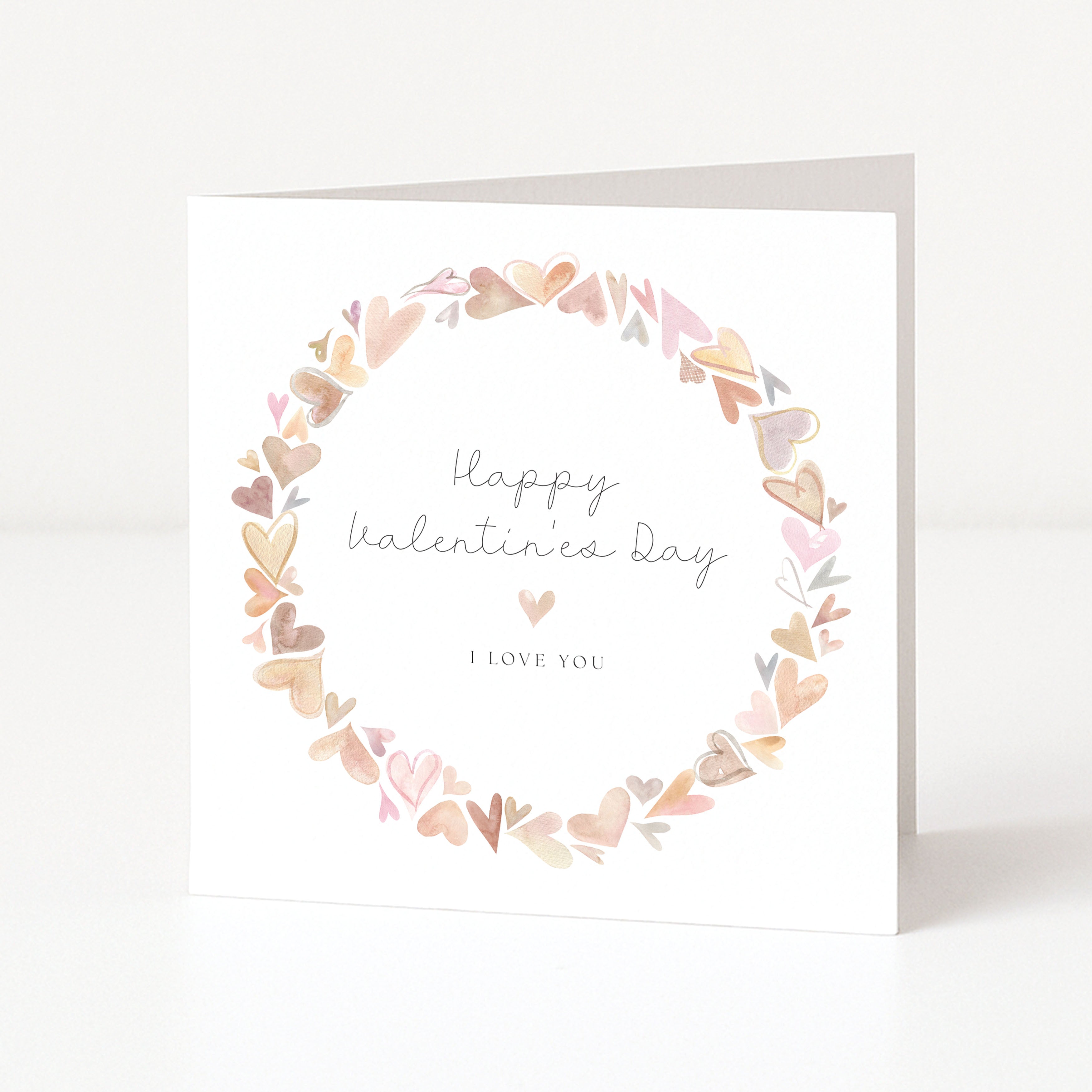 Valentine's Day card with heart wreath and 'Happy Valentine's Day, I love you' text on a white background