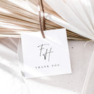 White card with 'THANK YOU' and initials 'FH' hanging on dried plants.