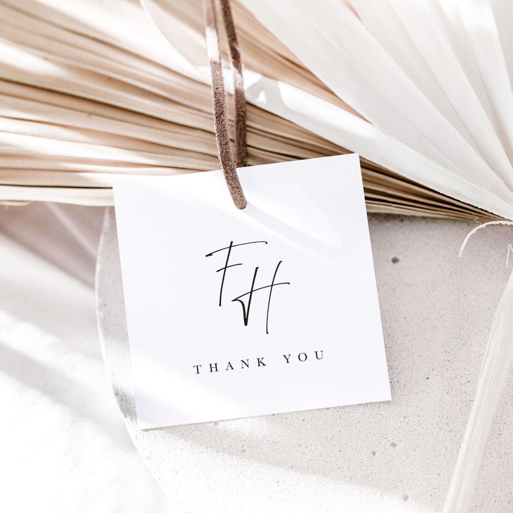 White card with 'THANK YOU' and initials 'FH' hanging on dried plants.