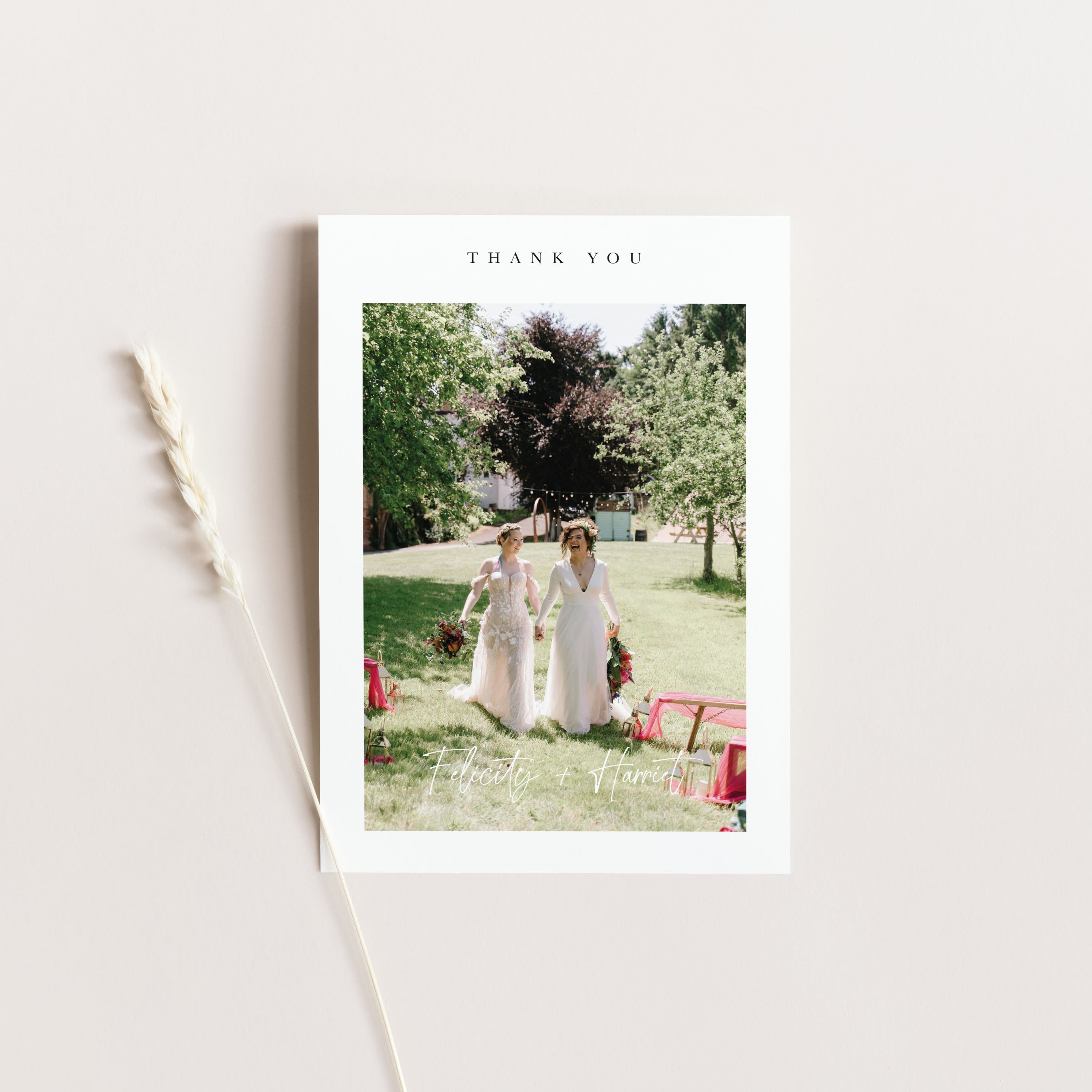 Wedding thank you card card with two women in white dresses holding hands on a grassy field, with 'Thank You' text above.