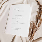 Wedding order of service on a soft fabric background with dried grasses