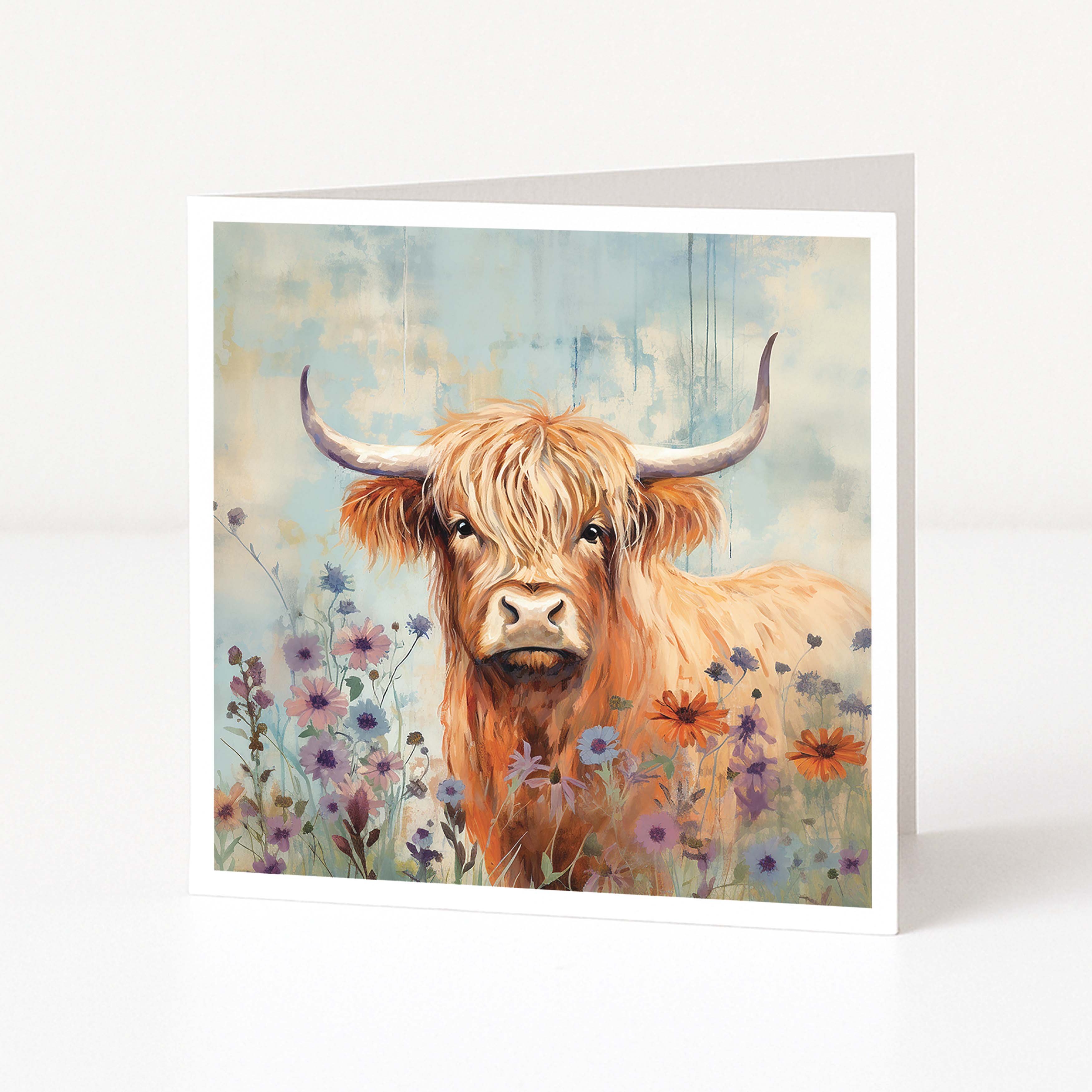 Greeting card with a painting of a highland cow in a field of flowers on a white background.