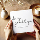 Person holding a card with 'Say goodbye to your toes' text on a wooden surface with decorative elements.