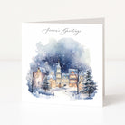 Winter scene with a town and trees on a greeting card with 'Season's Greetings' text.