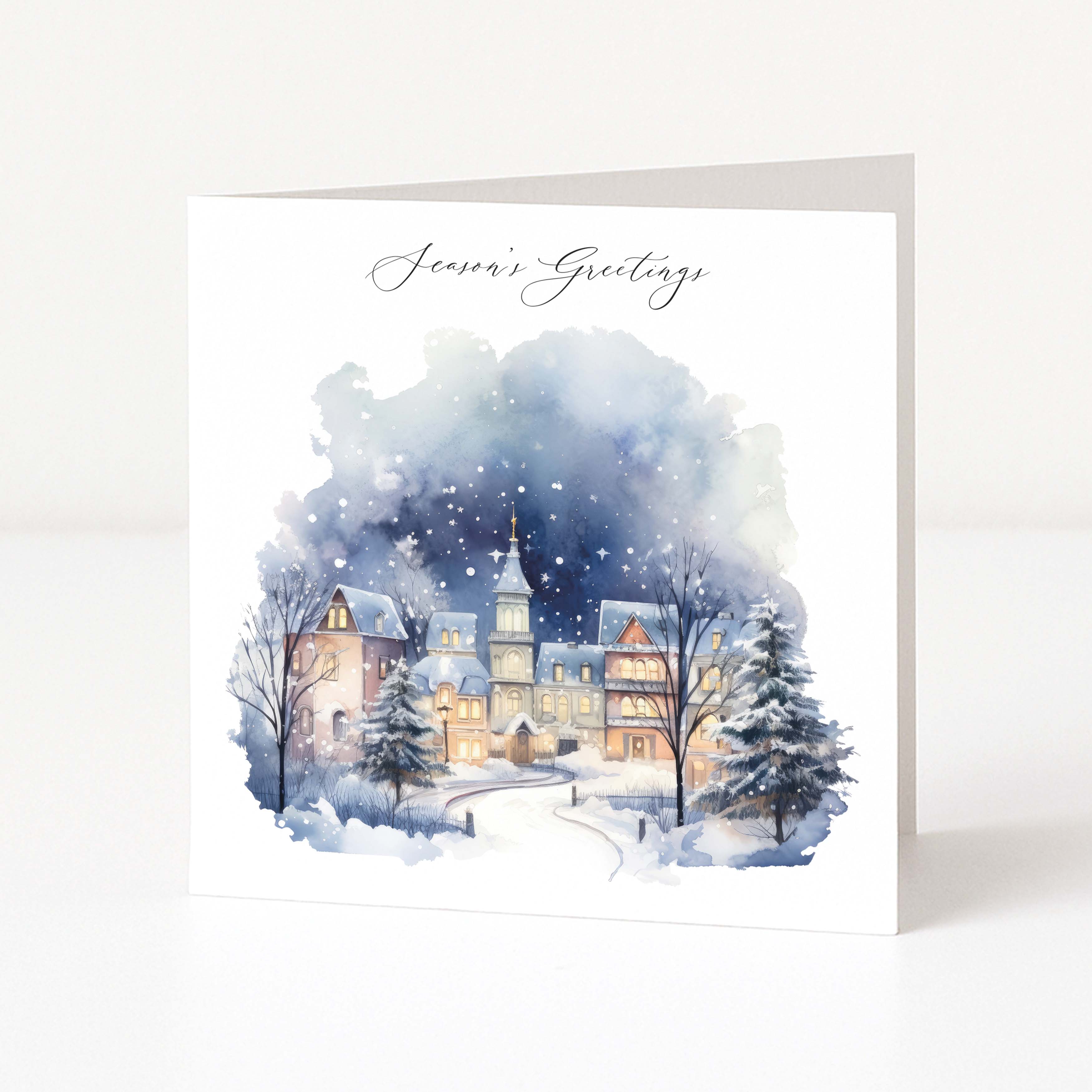 Winter scene with a town and trees on a greeting card with 'Season's Greetings' text.