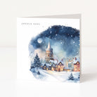 Christmas card with watercolour village scene and Joyeux Noel printed in the corner.