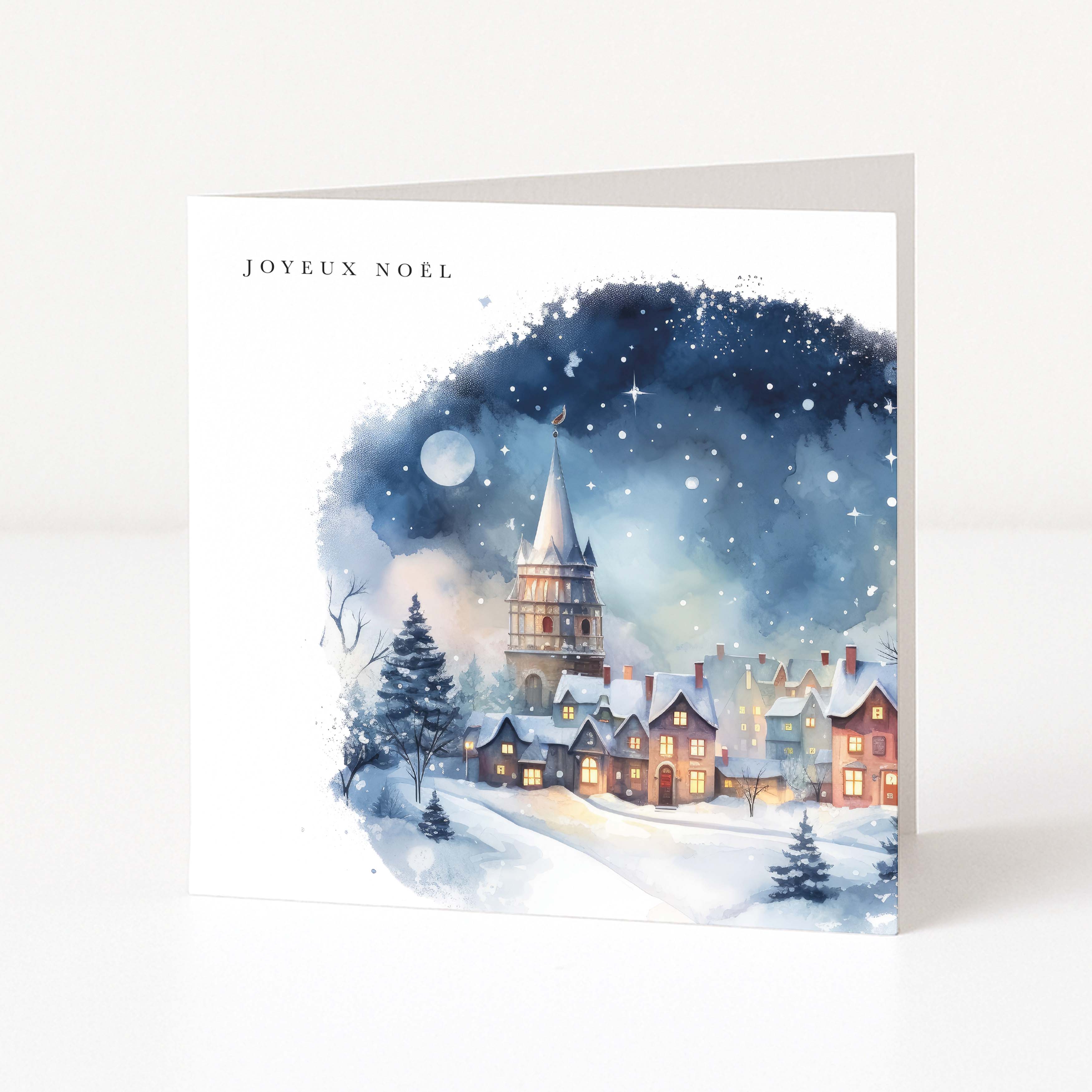Christmas card with watercolour village scene and Joyeux Noel printed in the corner.