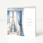 A square greeting card with a winter window illustration on the left side and the words 'warm winter wishes' on the right, shown standing against a clean white background.