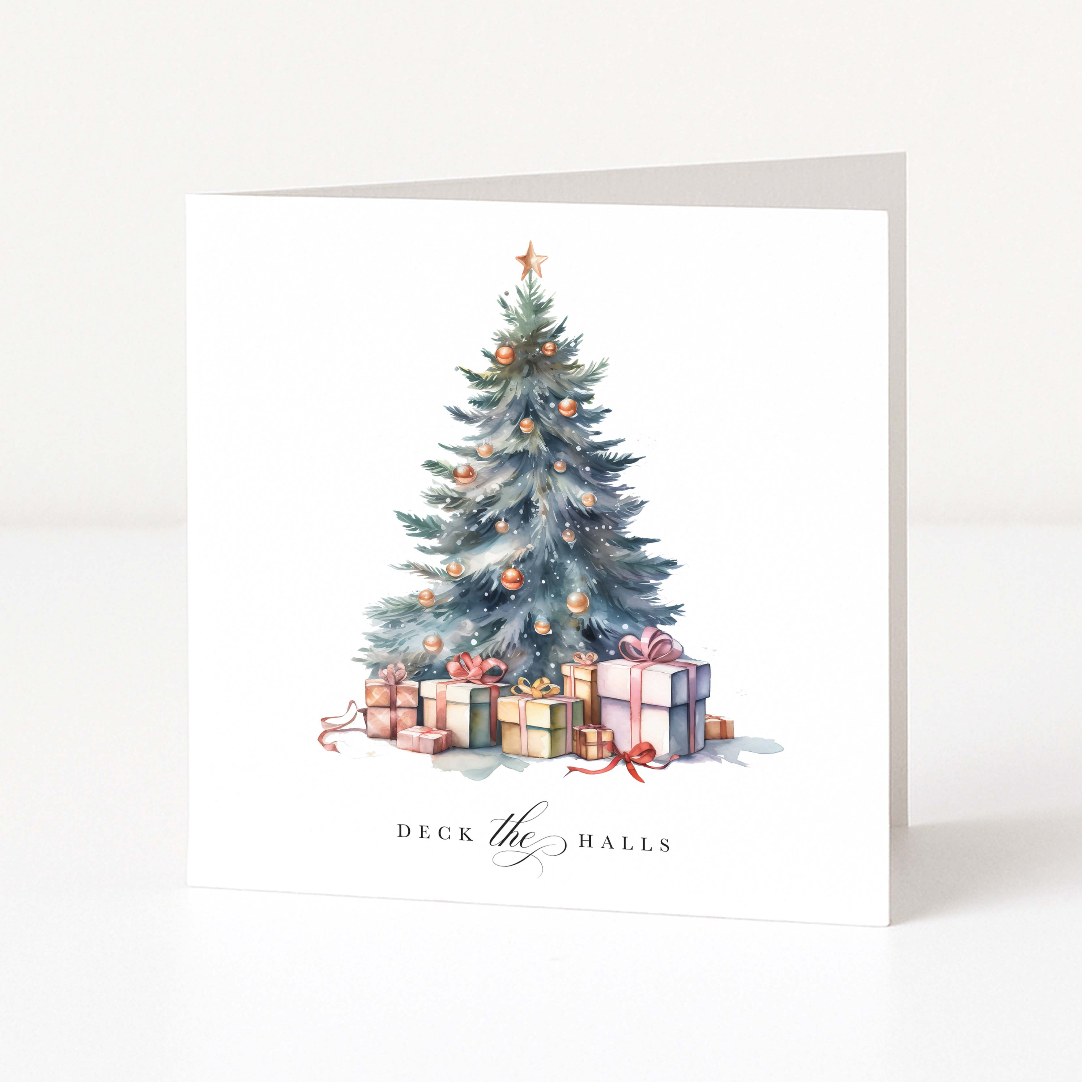 White Christmas Card depicting an illustrated Christmas tree and presents with "DECK the HALLS" printed in black text beneath