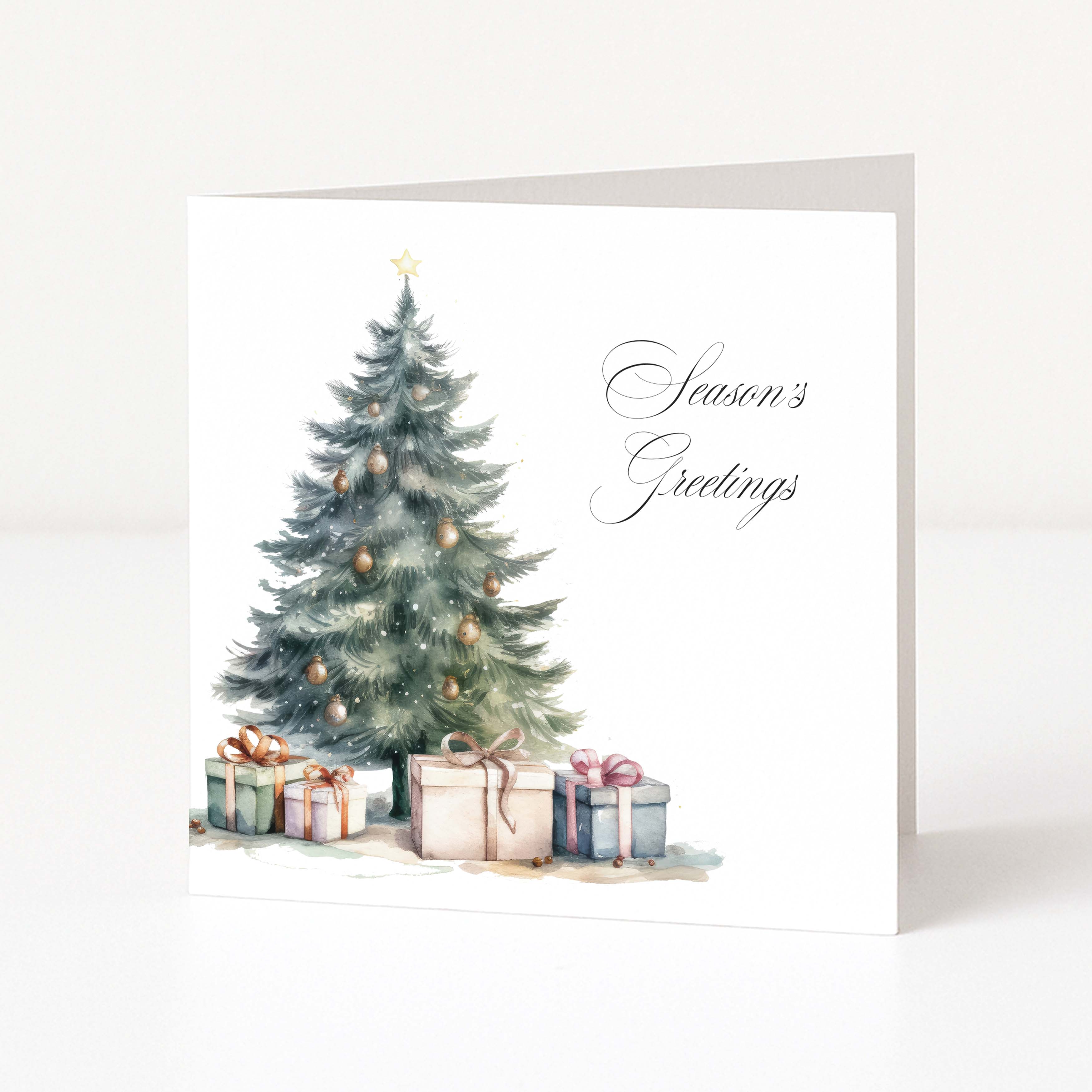 A square white Christmas greeting card standing upright, printed with a watercolour Christmas tree, ornaments, wrapped presents, and the words 'Season's Greetings' in black script.