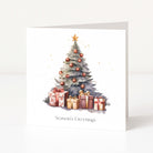 A white Christmas greeting card standing upright, printed with a watercolor-style Christmas tree decorated with gold ornaments and a gold star, with several wrapped presents at the base and the text 'Season's Greetings' near the bottom.