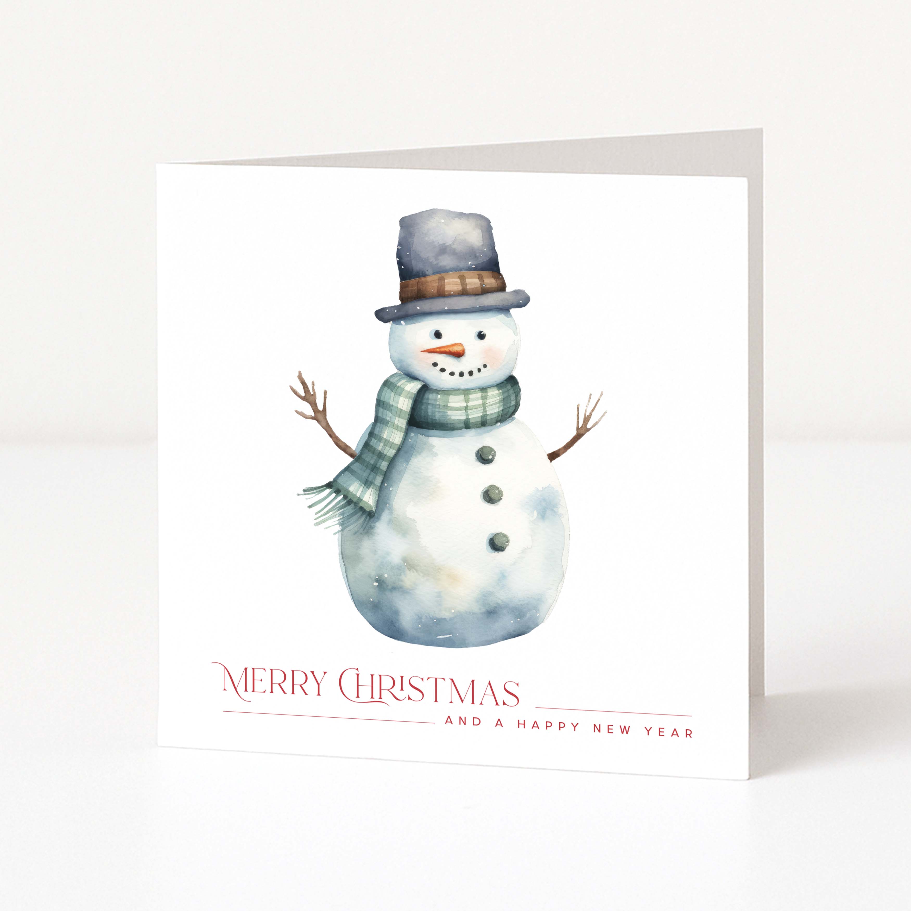A white Christmas greeting card featuring a watercolor illustration of a snowman wearing a gray top hat and green scarf, with the text 'MERRY CHRISTMAS AND A HAPPY NEW YEAR' printed below.
