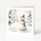A white Christmas greeting card showing an outdoor snowy scene, snowman and "Merry Christmas" sentiment in elegant script