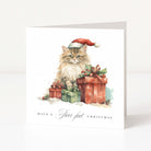 A square Christmas greeting card with a white background featuring an illustration of a fluffy cat wearing a Santa hat beside wrapped Christmas presents. The card reads 'HAVE A Purr-fect CHRISTMAS' at the bottom.