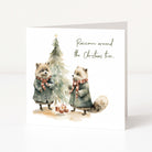 A Christmas greeting card with a Christmas tree, two raccoons and "raccoon around the Christmas tree..." text