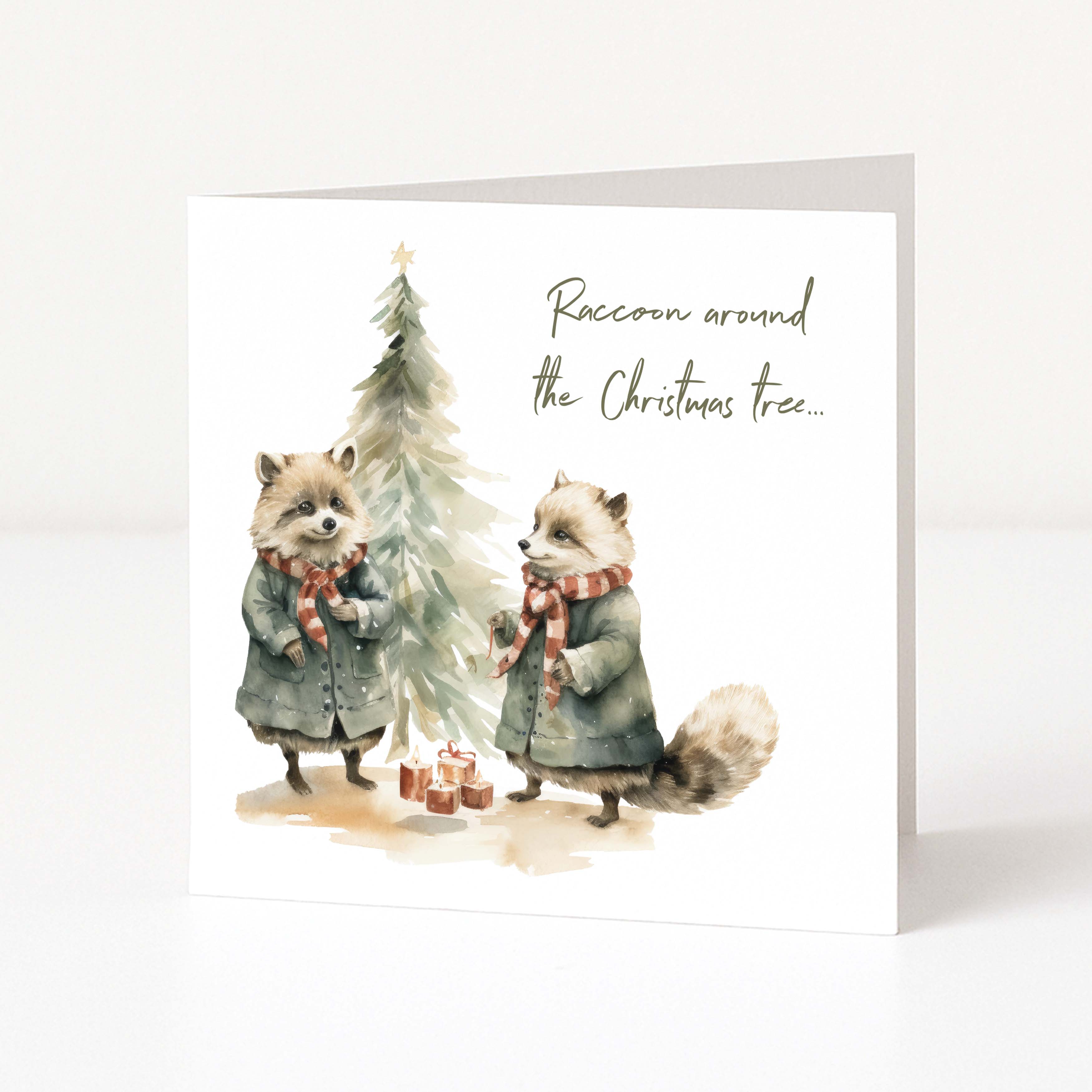 A Christmas greeting card with a Christmas tree, two raccoons and "raccoon around the Christmas tree..." text
