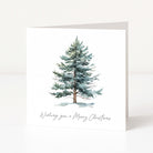 A square white Christmas greeting card with a watercolour illustration of a snow-dusted evergreen tree and the handwritten text 'Wishing you a Merry Christmas' at the bottom, shown standing against a clean white background.