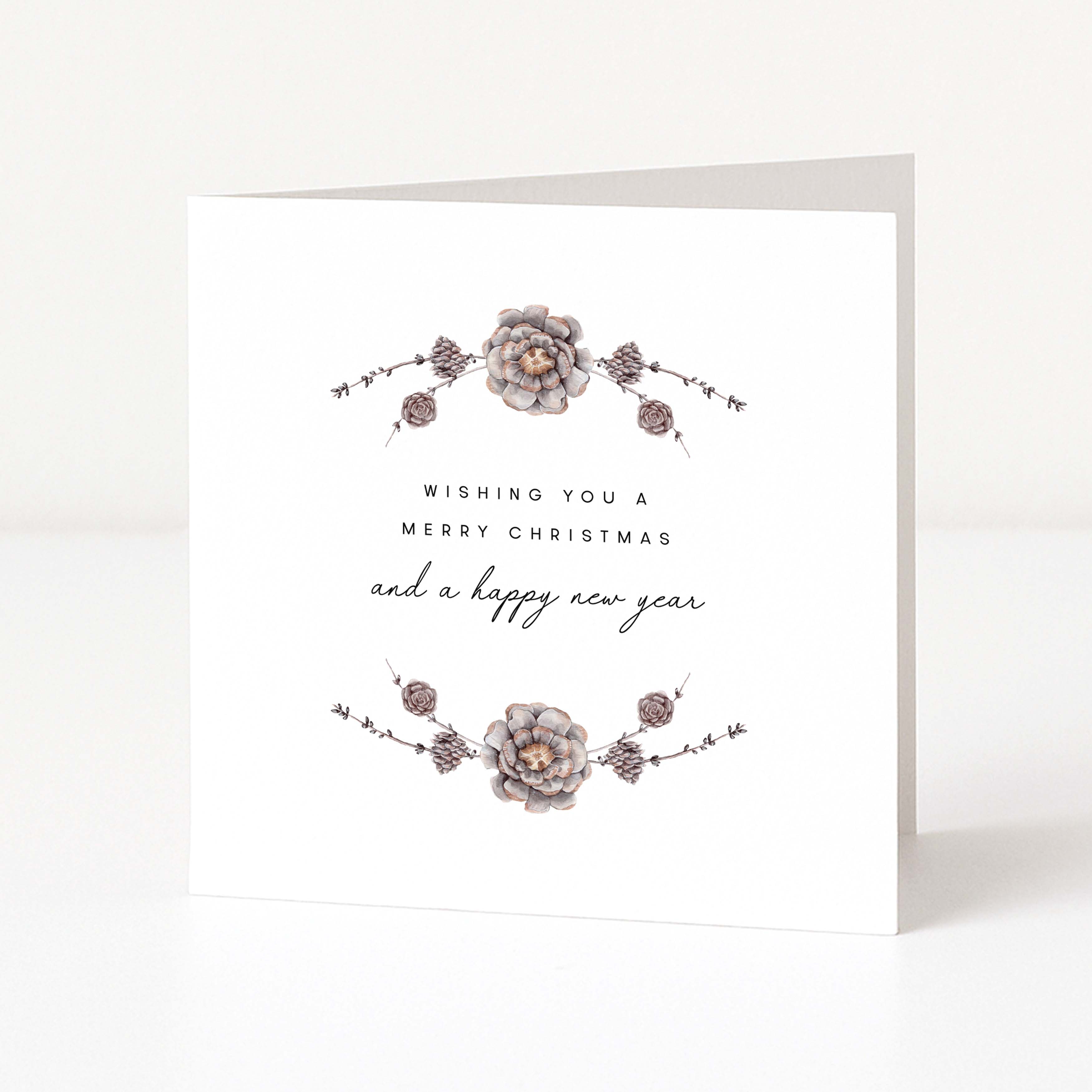 A white greeting card standing upright, featuring delicate floral illustrations in muted grey and taupe with the text 'Wishing you a Merry Christmas and a happy new year' in black script and serif type.