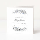 A white greeting card standing upright on a light grey surface, with delicate botanical illustrations in black and pale blue at the top and bottom and the text 'Wishing you a Merry Christmas and a Happy New Year' in the centre.