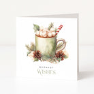 A white Christmas greeting card standing upright, featuring a watercolour illustration of a mug filled with marshmallows and a candy cane, surrounded by pinecones, berries, and greenery, with the text 'WARMEST WISHES' below.