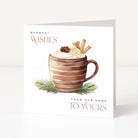 A square white Christmas greeting card standing upright on a light neutral surface. The front features an illustration of a striped brown mug filled with whipped cream and holiday toppings, with green pine branches at the base and the text 'WARMEST WISHES' and 'FROM OUR HOME TO YOURS'.