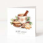 A square white Christmas greeting card with a festive illustration of a mug of hot cocoa with cinnamon sticks, cookies, holly leaves, and red berries. Below the illustration, the text reads 'it's the season TO BE JOLLY' in black and red script.