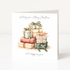 A square white Christmas greeting card with a watercolor illustration of stacked Christmas presents in muted pastel colors. The card reads 'Wishing you a Merry Christmas' at the top and 'and a happy new year' at the bottom, photographed against a clean white background.