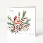 A square Christmas greeting card with a white background, featuring an illustration of a red cardinal perched among green pine branches and red berries. The card reads 'Merry Christmas' at the top and 'from our home to yours' at the bottom.