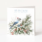 A square Christmas greeting card standing upright on a white surface, featuring a blue jay perched on snowy pine branches with red berries. The card reads 'ALL IS CALM ALL IS BRIGHT' in blue text at the top.
