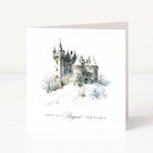 A white Christmas greeting card standing upright, featuring a watercolour illustration of a snowy castle with the text 'HAVE A Magical CHRISTMAS' printed below.