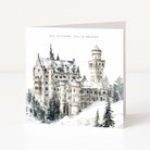 A square greeting card featuring a watercolour-style winter illustration of a snow-covered castle with the text 'ALL IS CALM, ALL IS BRIGHT' at the top, photographed on a clean white background.