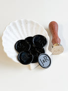 Close up of black wedding wax seals, adding a luxurious and classic touch to wedding invitations