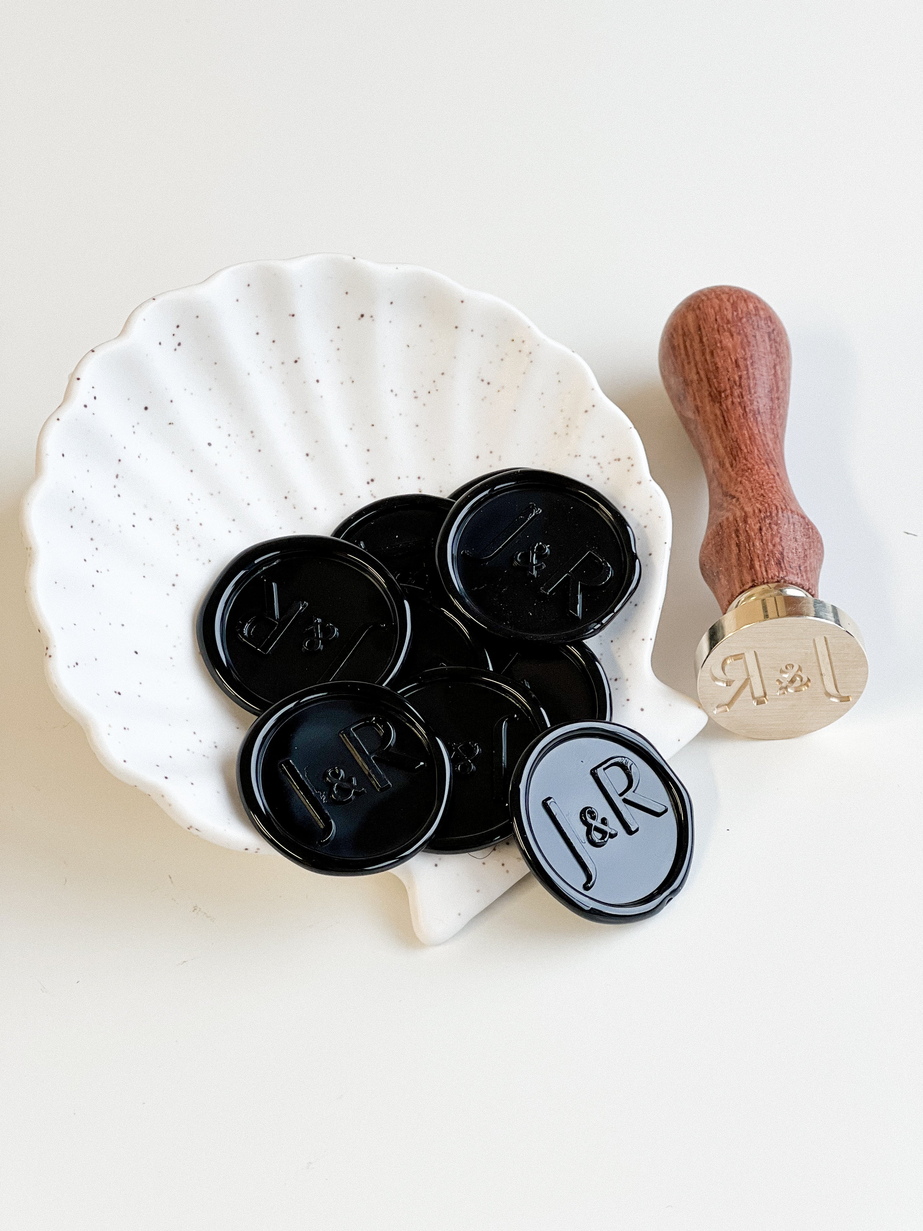 Close up of black wedding wax seals, adding a luxurious and classic touch to wedding invitations