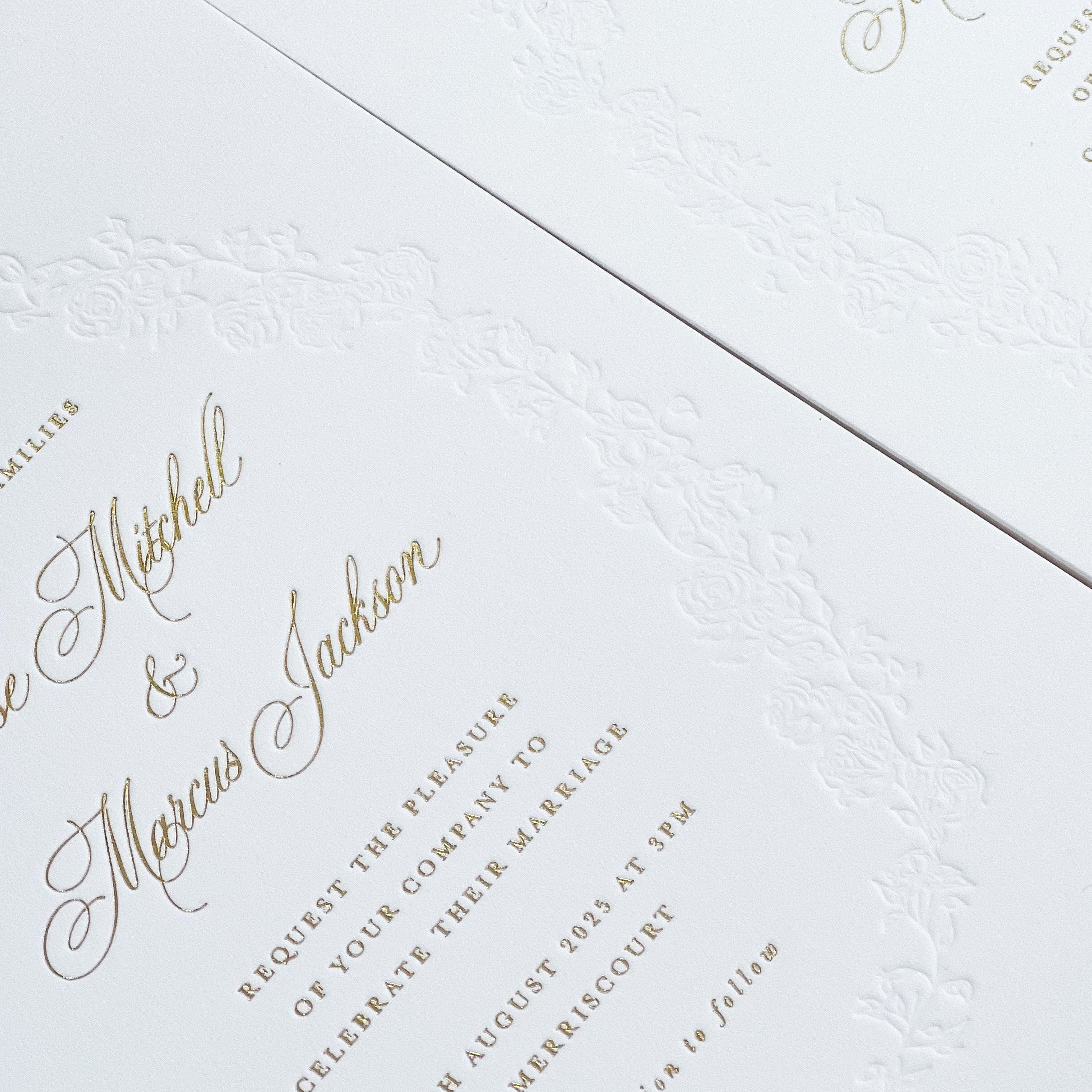 Wedding invitation with hot foiling and floral debossed border