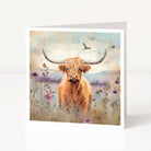 Greeting card with a highland cow in a field of flowers and birds.