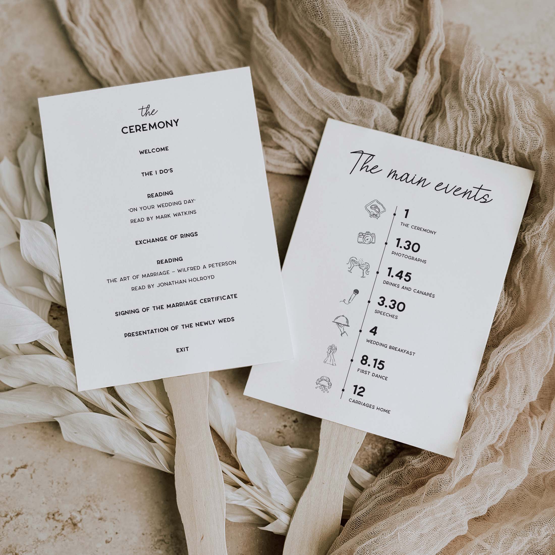 Two printed wedding program cards laid on beige fabric with dried flowers. One card reads 'the CEREMONY' with welcome text, and the other reads 'The main events' with timing icons and notes.