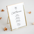 A cake flavours sign for a wedding shown in a gold frame and personalised with the names of the couple and wedding date and the bottom