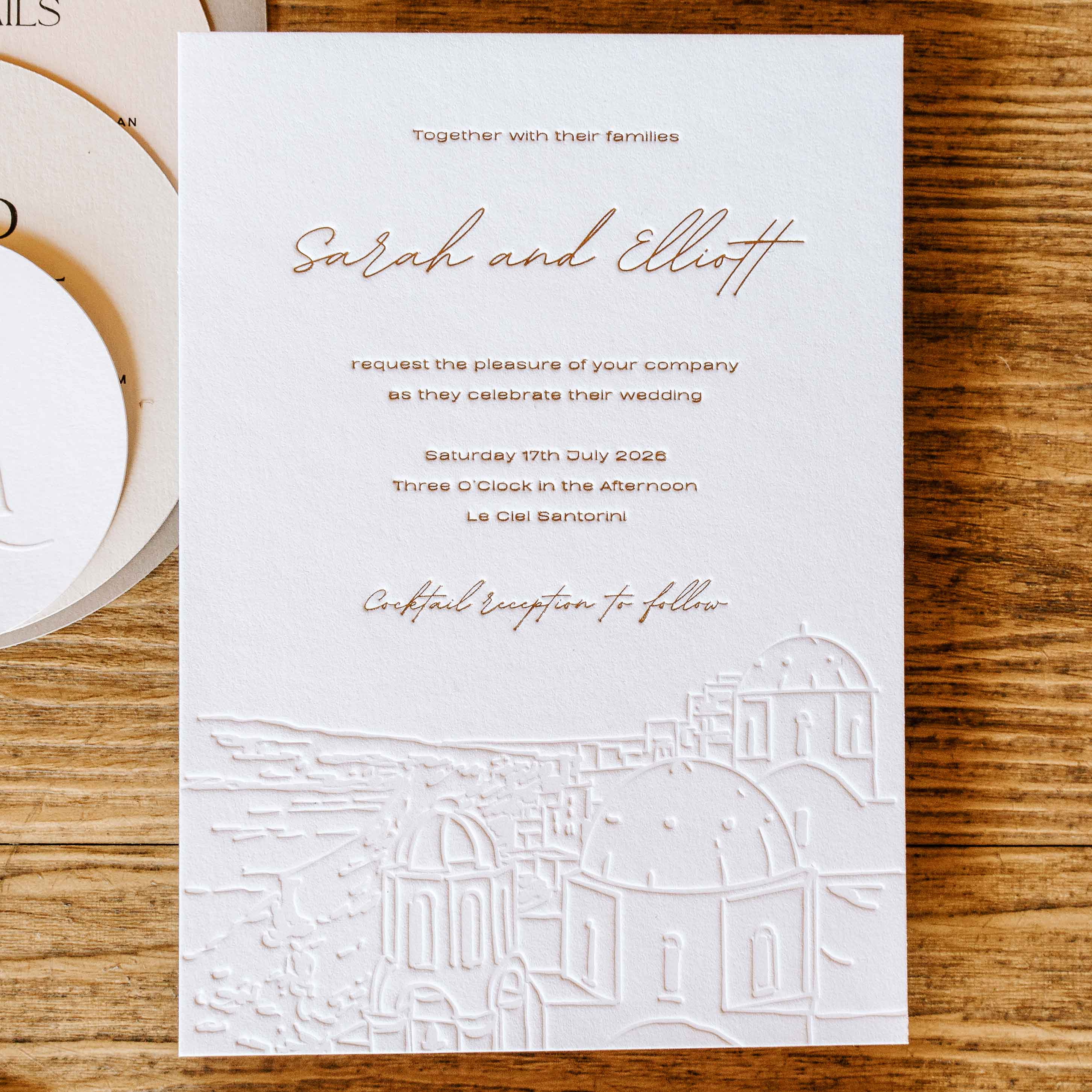 Letterpress and Foil Press Wedding invitation card with elegant design on a wooden surface