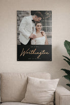 Wall art with a couple and text on a beige wall above a sofa.