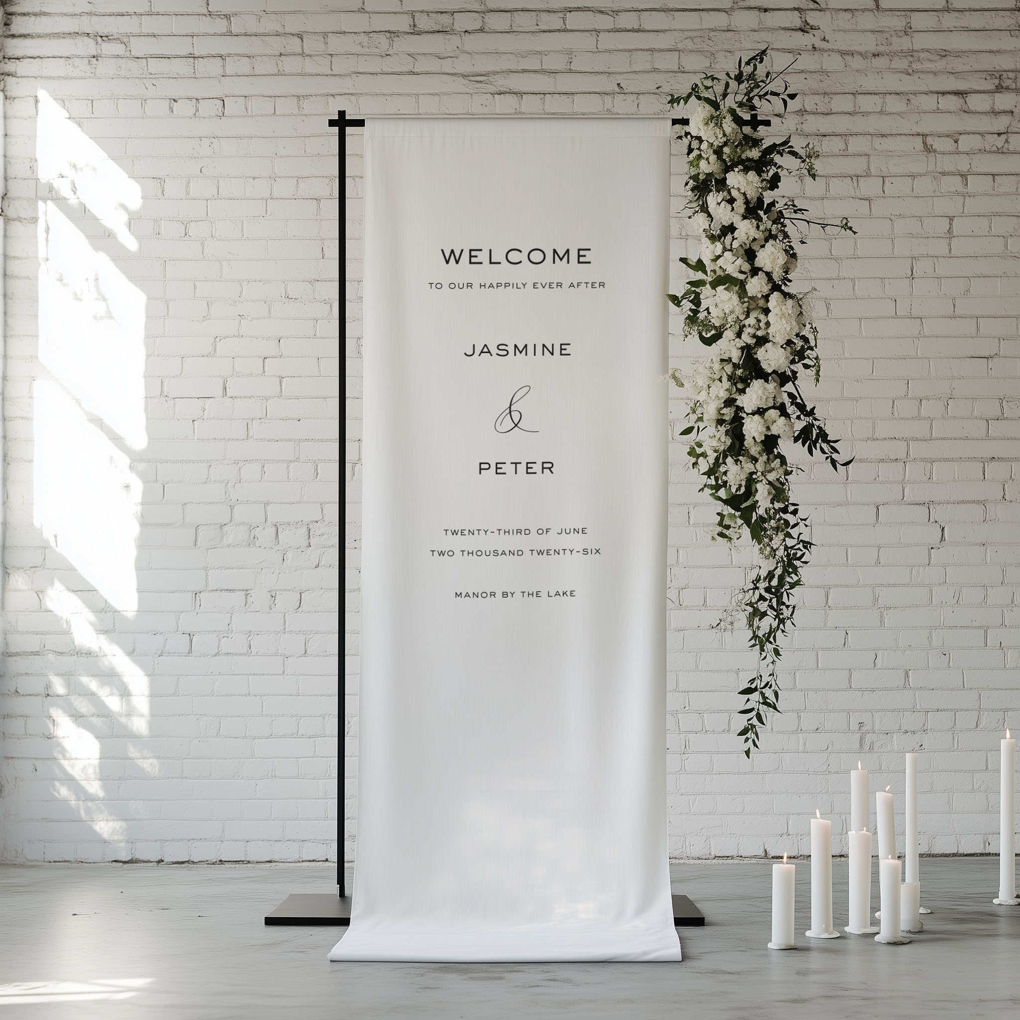 Modern and Minimalist Cotton Linen Wedding Welcome Sign shown hanging from a black frame with white flowers