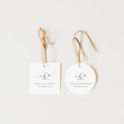 Two white tags with 'J & P' initials and 'Thank you for sharing our special day' text on a light beige background.