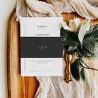 Wedding invitation suite on a wooden board with flowers