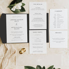 Wedding invitation set with details on a wooden surface