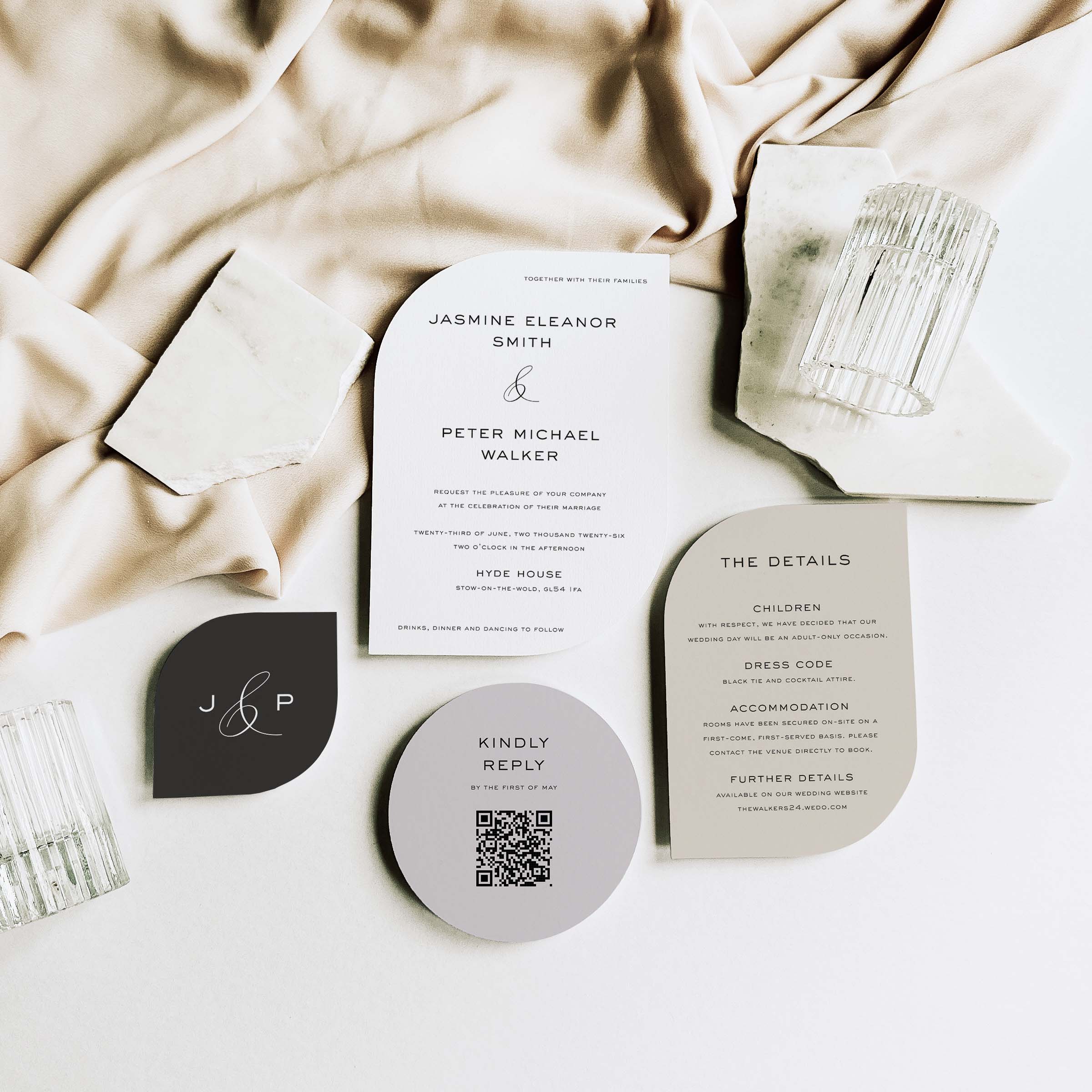 Shaped Wedding invitation set with RSVP card and QR code on a neutral fabric background